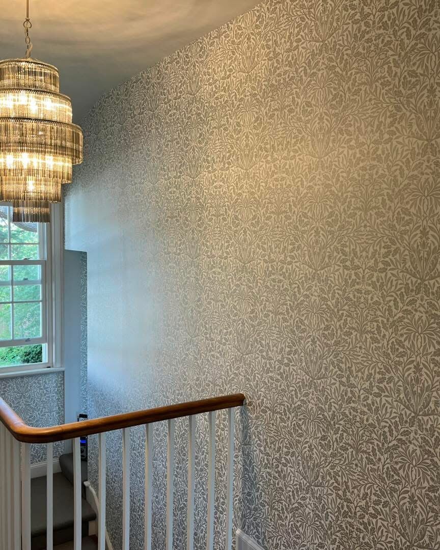 Staircase and landing with patterned wallpaper feature