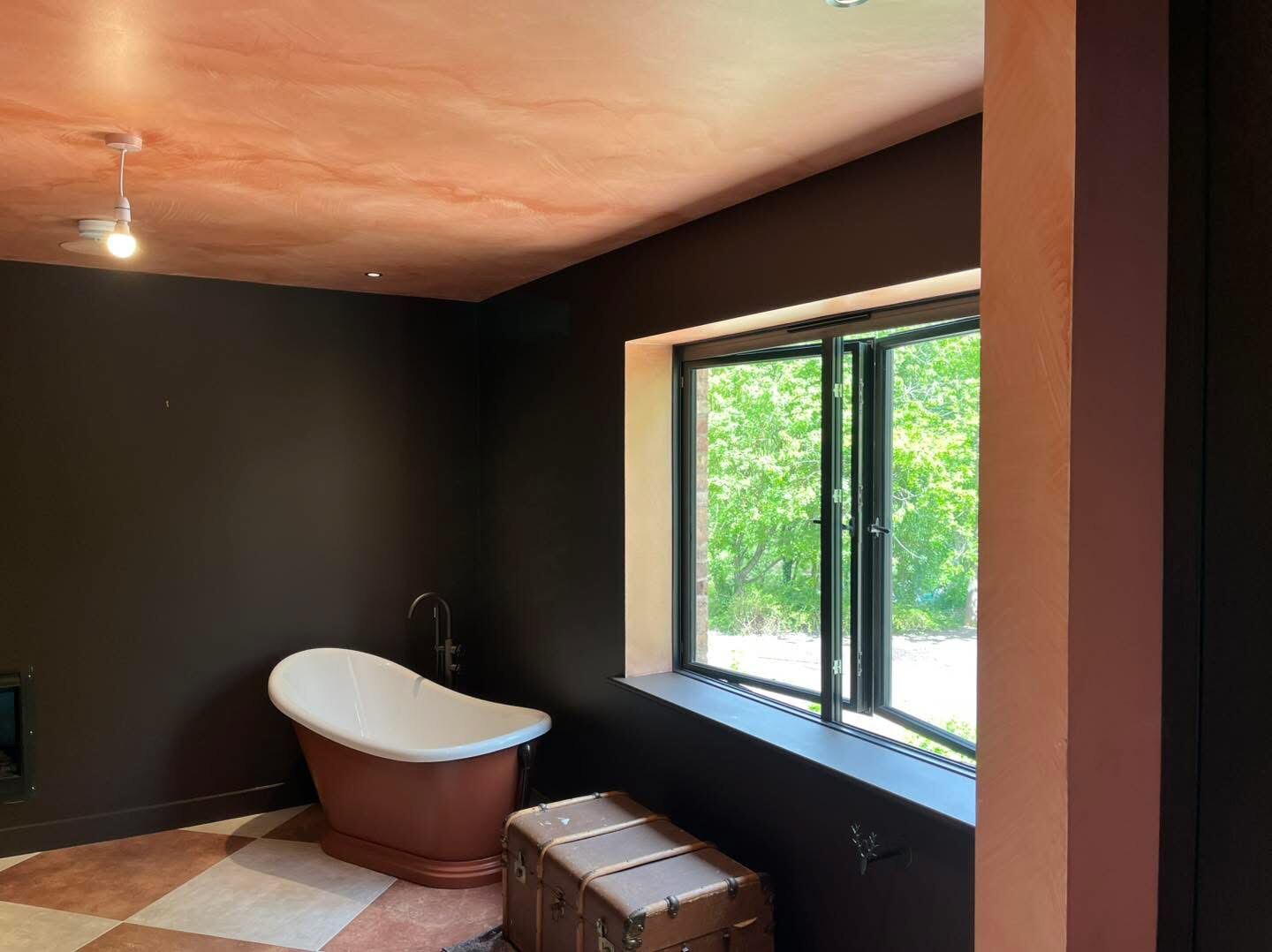 Luxury bathroom with freestanding bath and garden view