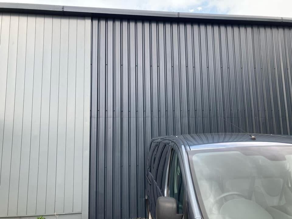 Industrial unit exterior cladding, spray coated