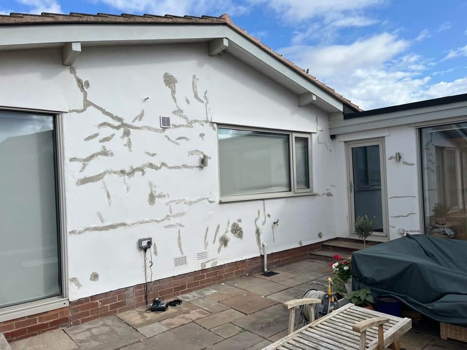 Bungalow exterior before repaint, cracked and weathered render