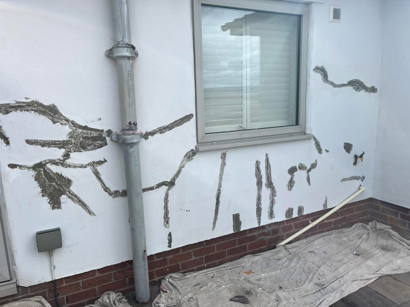Bungalow exterior render repair in progress