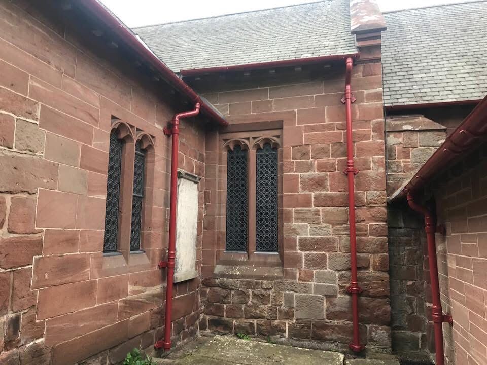 Church building exterior, drainpipe restoration detail