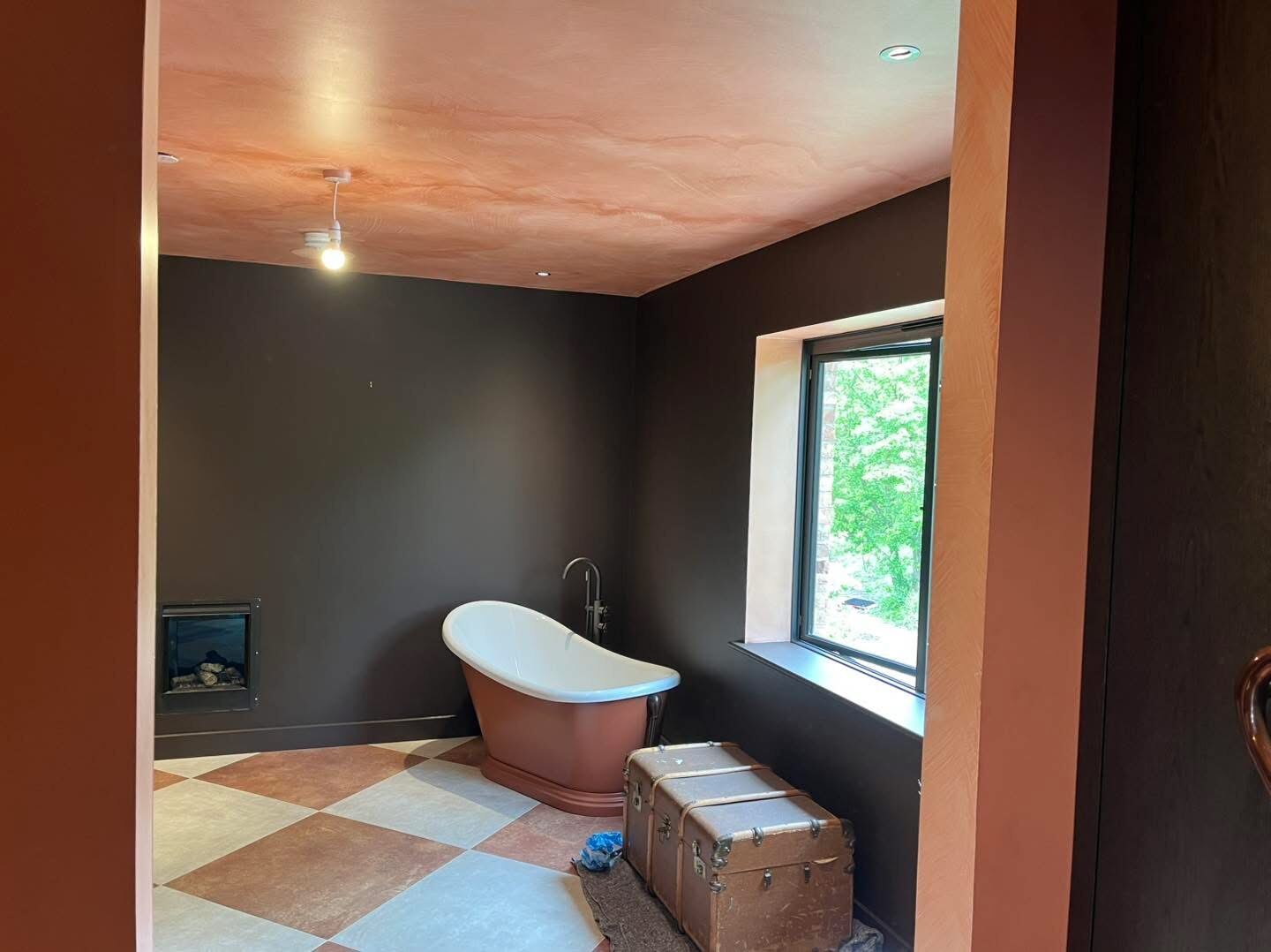 Luxury bathroom with freestanding bath and dark walls