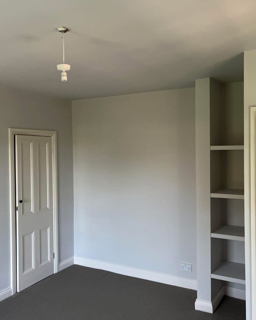Bedroom with fitted shelving, freshly painted